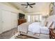 Comfortable primary bedroom with a ceiling fan, TV, carpet and a bay window offering natural light at 11182 S Hopi Dr, Goodyear, AZ 85338
