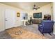 This home office has a work station area with TV and cabinet and a door leading to the house at 11182 S Hopi Dr, Goodyear, AZ 85338
