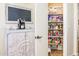View of a well-stocked pantry with shelves of various food items and cabinet with coffee maker at 11182 S Hopi Dr, Goodyear, AZ 85338