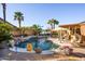 Gorgeous backyard pool area with mature palm trees, relaxing water feature and comfortable lounge area at 11182 S Hopi Dr, Goodyear, AZ 85338