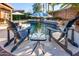 Relaxing poolside featuring comfortable lounge chairs and umbrellas, perfect for outdoor enjoyment at 11182 S Hopi Dr, Goodyear, AZ 85338
