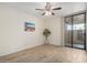 Bright bedroom with tiled floors, ceiling fan, and sliding glass door at 1125 E Broadway Rd # 102, Tempe, AZ 85282