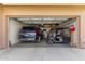 Well-organized two-car garage with ample storage space for vehicles and other items at 11263 E Nell Ave, Mesa, AZ 85209