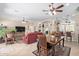 Bright and airy living area with a dining table, red leather sofas, and a view into other rooms at 11263 E Nell Ave, Mesa, AZ 85209