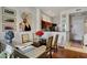 Open dining room view with art, view of kitchen and hardwood floors at 11640 N Tatum Blvd # 3069, Phoenix, AZ 85028
