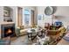Inviting living room featuring a fireplace, large window, and stylish furnishings at 11640 N Tatum Blvd # 3069, Phoenix, AZ 85028