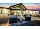 The modern home has a large patio furnished with sophisticated outdoor seating, perfect for entertaining and relaxation at 12201 N 65Th St, Scottsdale, AZ 85254
