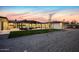 Scenic backyard with stone-paved patio, pergola-covered seating, lush green grass, and decorative landscaping at 12201 N 65Th St, Scottsdale, AZ 85254