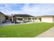 Lush backyard featuring an expansive patio, modern pergola, and green lawn at 12201 N 65Th St, Scottsdale, AZ 85254
