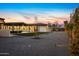 A peaceful backyard featuring gravel, green grass, and a covered patio with outdoor seating and dining at 12201 N 65Th St, Scottsdale, AZ 85254