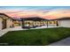Expansive backyard with a covered patio, comfortable seating, and lush landscaping, ideal for outdoor entertaining at 12201 N 65Th St, Scottsdale, AZ 85254