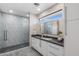 Bright bathroom featuring a glass-enclosed shower, modern vanity with ample storage, and designer finishes at 12201 N 65Th St, Scottsdale, AZ 85254