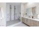 Bathroom featuring walk-in shower with dual shower heads, double vanity, and modern fixtures at 12201 N 65Th St, Scottsdale, AZ 85254