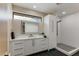Modern bathroom featuring a sleek vanity, decorative mirror, and walk-in shower with stylish tile at 12201 N 65Th St, Scottsdale, AZ 85254