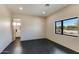 Bedroom with a large window, dark tile floor, and an ensuite bathroom at 12201 N 65Th St, Scottsdale, AZ 85254