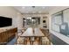 Spacious dining room with a large table, contemporary artwork, and views to the outdoor patio at 12201 N 65Th St, Scottsdale, AZ 85254