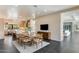 Open concept dining room featuring stylish decor, views to the kitchen, living room, and a modern lighting fixture at 12201 N 65Th St, Scottsdale, AZ 85254