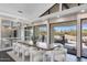 Elegant dining area with stylish seating, natural light, and views of the outdoor patio at 12201 N 65Th St, Scottsdale, AZ 85254
