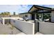 Beautiful front patio with desert landscaping, modern seating, gated entry, and sleek, contemporary design elements at 12201 N 65Th St, Scottsdale, AZ 85254