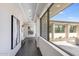 Hallway leading to an outdoor patio, features modern artwork and bright lighting at 12201 N 65Th St, Scottsdale, AZ 85254