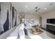 Spacious living room featuring stylish decor, contemporary artwork, and comfortable seating, with a ceiling fan at 12201 N 65Th St, Scottsdale, AZ 85254