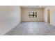 Bright living room featuring neutral paint, large tile floors, and a window showcasing the natural surroundings at 12201 N 65Th St, Scottsdale, AZ 85254