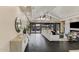 Spacious living area flowing to patio, with stylish furniture, fireplace, and decorative wine cellar at 12201 N 65Th St, Scottsdale, AZ 85254