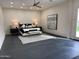 Bright main bedroom featuring a king bed, neutral colors, and a decorative rug at 12201 N 65Th St, Scottsdale, AZ 85254