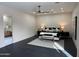 Spacious main bedroom featuring a ceiling fan, neutral colors, and dark tile floors at 12201 N 65Th St, Scottsdale, AZ 85254