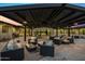 Inviting outdoor patio featuring comfortable seating and an outdoor kitchen, perfect for entertaining and relaxation at 12201 N 65Th St, Scottsdale, AZ 85254