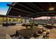 Wide patio area with covered pergola, dining table, and ample outdoor seating for luxury outdoor living at 12201 N 65Th St, Scottsdale, AZ 85254