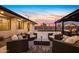Patio area offering several cozy wicker seating spots, and lush plants; ideal for relaxing and conversation at 12201 N 65Th St, Scottsdale, AZ 85254