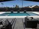 Inviting pool featuring water features and travertine tile, surrounded by a modern patio and comfortable lounge furniture at 12201 N 65Th St, Scottsdale, AZ 85254