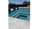 Inviting pool with a built-in spa, surrounded by modern water features and stylish travertine tile at 12201 N 65Th St, Scottsdale, AZ 85254