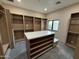 Walk-in closet with custom shelving, a center island, and ample storage solutions at 12201 N 65Th St, Scottsdale, AZ 85254