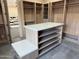 Custom walk-in closet with shelving, drawers, and a center island for organization at 12201 N 65Th St, Scottsdale, AZ 85254