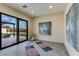 Bright yoga room with large glass doors to the backyard, yoga mats, and peaceful decor for relaxation at 12201 N 65Th St, Scottsdale, AZ 85254