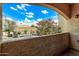 Balcony view showcasing vibrant trees, a parking lot, and clear blue skies at 12221 W Bell Rd # 249, Surprise, AZ 85378