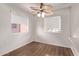 Well-lit bedroom showcasing a wood floor, a fan, and two windows at 12221 W Bell Rd # 249, Surprise, AZ 85378