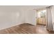 Cozy bedroom featuring wood floors and access to a balcony at 12221 W Bell Rd # 249, Surprise, AZ 85378