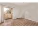 Bright bedroom with a sliding glass door to a balcony, wood floors, and white walls at 12221 W Bell Rd # 249, Surprise, AZ 85378