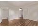 Bright, empty bedroom featuring wood-look floors with access to bath and closet at 12221 W Bell Rd # 249, Surprise, AZ 85378
