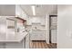 Functional kitchen featuring a dishwasher, range, white cabinetry and view to laundry machines at 12221 W Bell Rd # 249, Surprise, AZ 85378