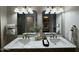 Bathroom with a double marble vanity, gold fixtures, and a large mirror, providing a luxurious feel at 1237 N Kenneth Pl, Chandler, AZ 85226