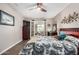 Spacious bedroom featuring French doors to the patio, wood-look flooring, and ample natural light for a comfortable living at 13009 N 100Th Dr, Sun City, AZ 85351