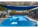 In-ground pool with diving board and slide shaded by sails, creating a fun and inviting backyard oasis at 13201 N 24Th Ave, Phoenix, AZ 85029