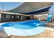 Resort style in-ground pool with shade sails and slide, perfect for summer fun and relaxation at 13201 N 24Th Ave, Phoenix, AZ 85029