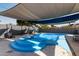 Resort style in-ground pool with slide and diving board under shade sails for Gathering fun and entertaining at 13201 N 24Th Ave, Phoenix, AZ 85029