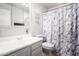 Bright bathroom featuring a single vanity, mirrored medicine cabinet, and decorative shower curtain at 13201 N 24Th Ave, Phoenix, AZ 85029