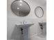 Bright bathroom with dual sinks, stylish round mirrors, and sleek, modern fixtures at 13201 N 24Th Ave, Phoenix, AZ 85029